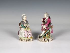 A pair of Sampson porcelain figurines modelled depicting a seated young lady and a dandy, with