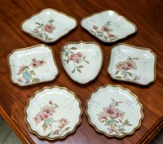 A late 19th century Wedgwood part dessert service well painted with flowers and gilding in the