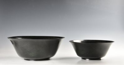 A graduated pair of Chinese deep spinach green jade bowls probably 20th century, of deep, rounded