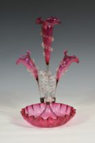 A Victorian cranberry glass epergne with central trumpet spill with wavy edge clear glass spiral