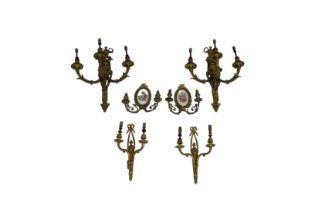 A group of six 20th century gilt metal wall lights comprising a pair of twin branched wall lights