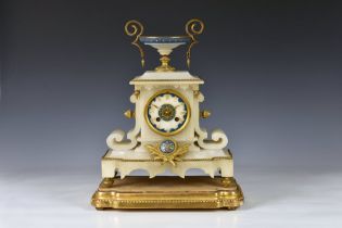 A 19th century French alabaster cased mantel clock surmounted by a squat lidless urn with gilt metal