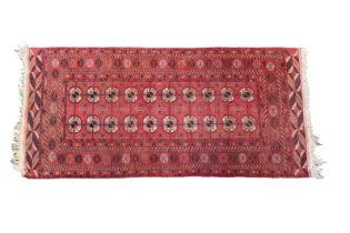 A Turkoman rug, Andkhoy region, northern Afghanistan, with two rows of ten Guls flanked by a rosette