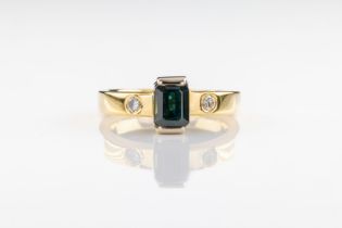 A tourmaline and diamond ring The emerald-cut blue green tourmaline flanked by brilliant cut