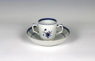 A Chinese export blue & white porcelain chocolate cup and saucer having floral spray with gilt