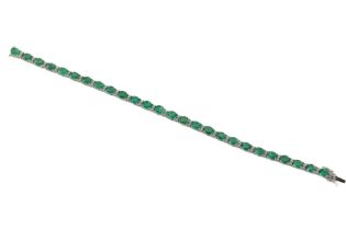 An emerald and diamond line bracelet The oval cut emeralds totalling approximately 7.60cts spaced