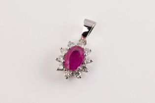 A ruby and diamond cluster pendant The central oval-shaped ruby weighing approximately 0.78cts in
