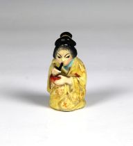 A Royal Worcester figural candle snuffer fashioned as a Japanese Geisha girl, puce mark, 2¾in. (