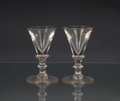 A pair of 18th century wine glasses funnel bowl, knopped stem, pontil beneath, 4¼in. (10.8cm.). *