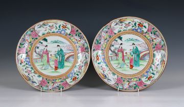 A pair of 20th century Chinese porcelain plates in the famille rose palette, the central