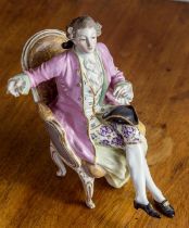 A Continental porcelain figure of a seated dandy 19th century, possibly La Courtille, seated in