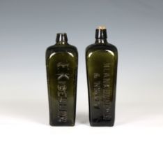 Two Dutch Geneva Gin bottles in dark green, of square tapering form with curved shoulder and short
