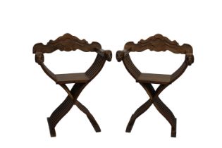 A Pair of Savonarola chairs 20th century, the foliate and scroll carved removable backs over