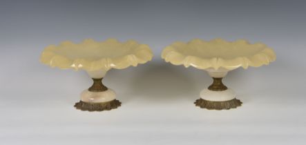 A pair of alabaster and gilt metal tazzas probably late 20th century, the dishes with crimped