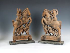 A pair of 20th Century Indian carved wood figures depicting warriors astride a horse leaping over