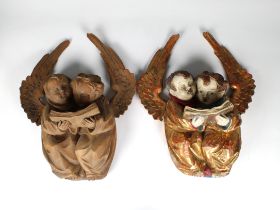 A pair of 20th Century carved wooden cherub wall hangings probably kunsthandlung PALS, each carved