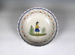 A Quimper French faience bowl depicting a single figure in a field, scalloped rim, monogrammed '