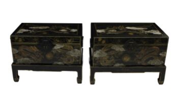 A pair of 20th century Chinese black lacquered and gilded wooden chests on stands decorated with