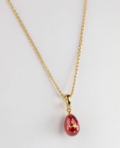 A Faberge Egg Pendant The 18ct yellow gold modern Faberge egg pendant, the egg in deep red guilloche