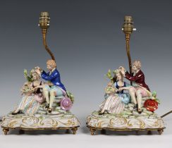 A pair of Capodimonte porcelain table lamps modelled as a courting couple on scrolling bases