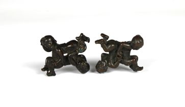A pair of Chinese bronze figures / scroll weights of 'si xi Tongzi' two tumbling boys possibly