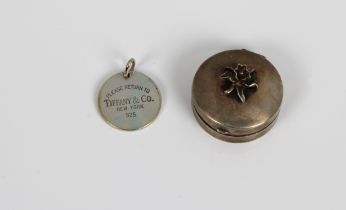 A Bruce Russell of Guernsey miniature silver Lily trinket box and a Tiffany & Co silver bag tag. (