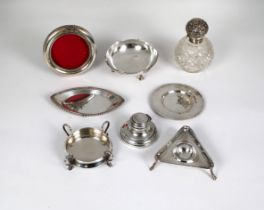 A collection of silver smalls to include a silver topped cut glass perfume bottle; circular