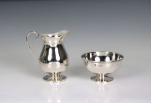 An Elizabeth II silver jug Harrods Ltd, Sheffield, 1963, of baluster form, 4¾in. (12.2cm.) high,