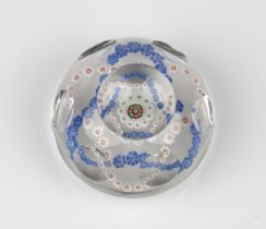 A Baccarat facetted / patterned millefiori glass paperweight the clear glass set with a trefoil