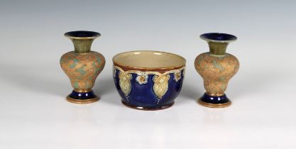 A pair of miniature Doulton Lambeth vases of squat baluster form, decorated with stylised floral