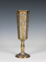 A Russian silver gilt goblet of elongated hexagonal form, having raised floral and foliate