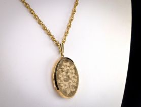 Large 9ct yellow gold locket The case chased and engrave with foliate design with bevelled edge,