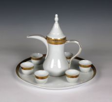 A 20th century Limoges white porcelain and part gilded arabic coffee pot (Dallah) with six