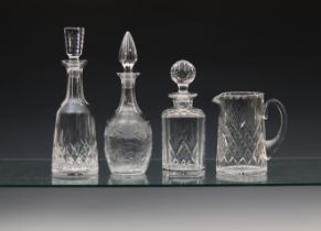 Three cut glass decanters to include a Waterford 'Lismore' decanter, 13 1/8in. (33.5cm.) high,