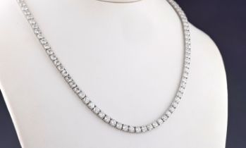 An 18ct white gold and diamond line necklace with one hundred and two claw set, brilliant cut