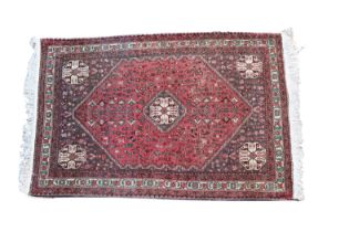 An Abadeh rug with a central medallion repeated to corners, within an extended lozenge field flanked