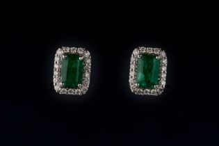 A pair of emerald and diamond cluster earrings Each emerald-cut emerald claw set in a diamond