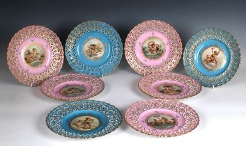 Eight late 19th century, Dresden style porcelain cabinet plates with pierced borders the centre with