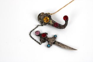 A silver filigree Berber dagger brooch set with semi precious stones silver & yellow metal safety