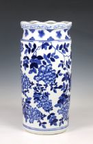A Chinese blue and white stick stand painted with flowering boughs and a floral band around the
