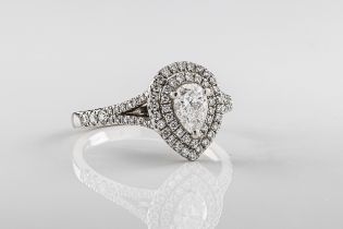 A platinum and diamond halo ring The 0.51 D SI2 pear cut diamond claw set within and double halo