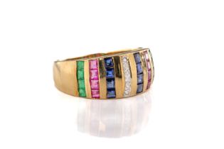 An 18ct yellow gold diamond, ruby, sapphire and emerald ring. The central band of brilliant-cut