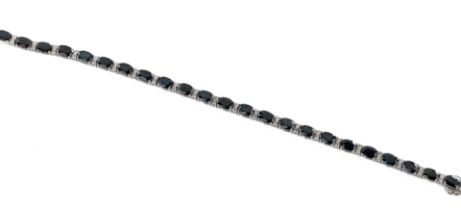 A sapphire and diamond line bracelet The oval cut sapphires totalling approximately 15.13cts