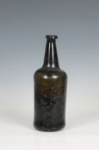 An 18th century cylinder wine bottle dark olive green, slightly waisted, tapered with tooled lip and
