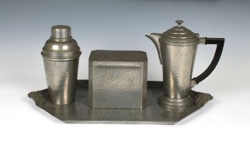 An Art Deco planished pewter matched cocktail set comprising a tray, stamped 'Craftsman', 17 7/