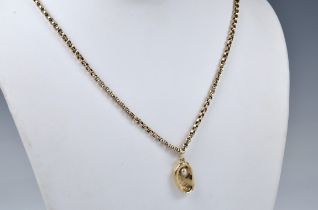 A 9ct gold and seed pearl ormer shell pendant the shell set with a single seed pearl to the
