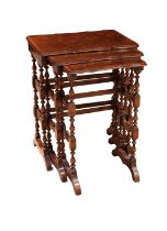 An early 20th century serpentine Burr walnut and tulipwood nest of three tables