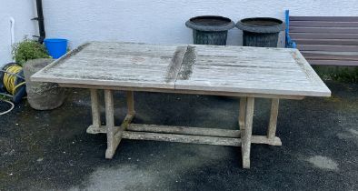 A large teak rectangular garden table