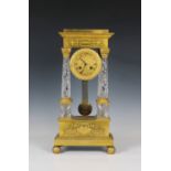 A French Charles X gilt bronze and cut crystal portico mantel clock