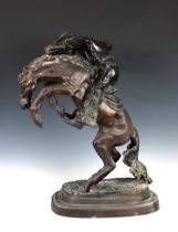A large bronze figure of a cowboy on horseback, in the manner of Frederick Remington